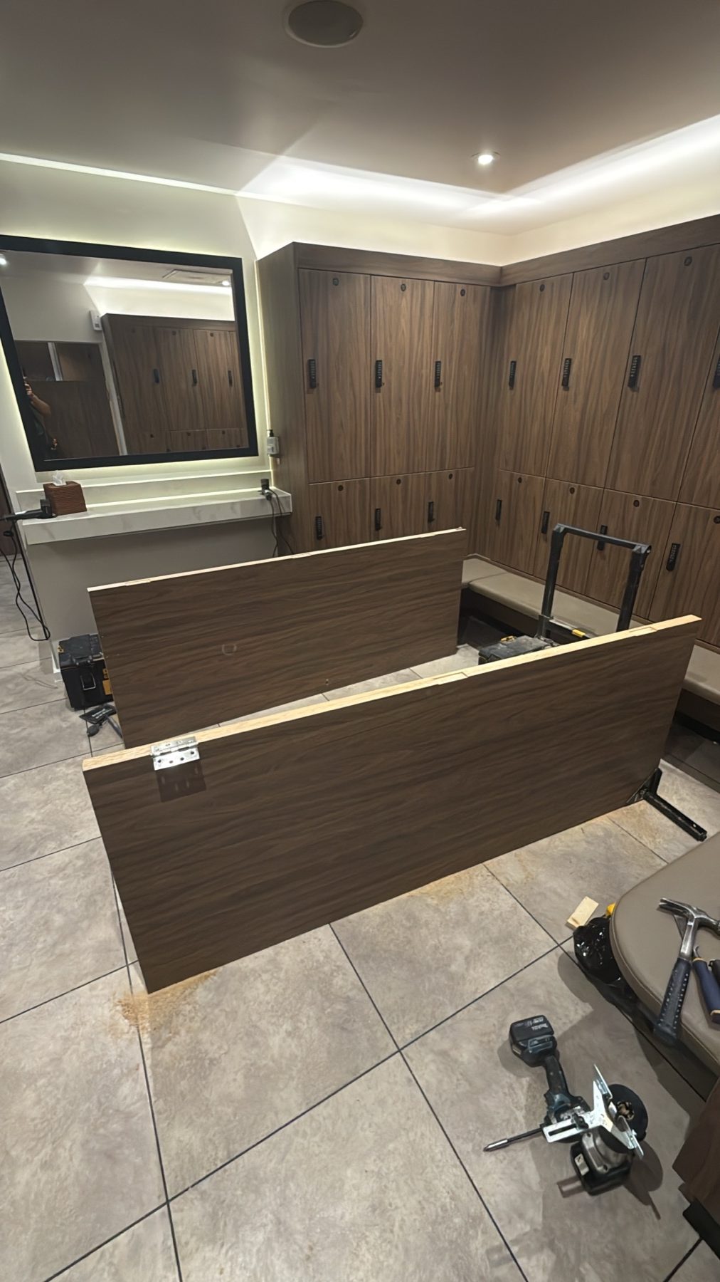 Timber-finished panels being fitted in the health club changing area